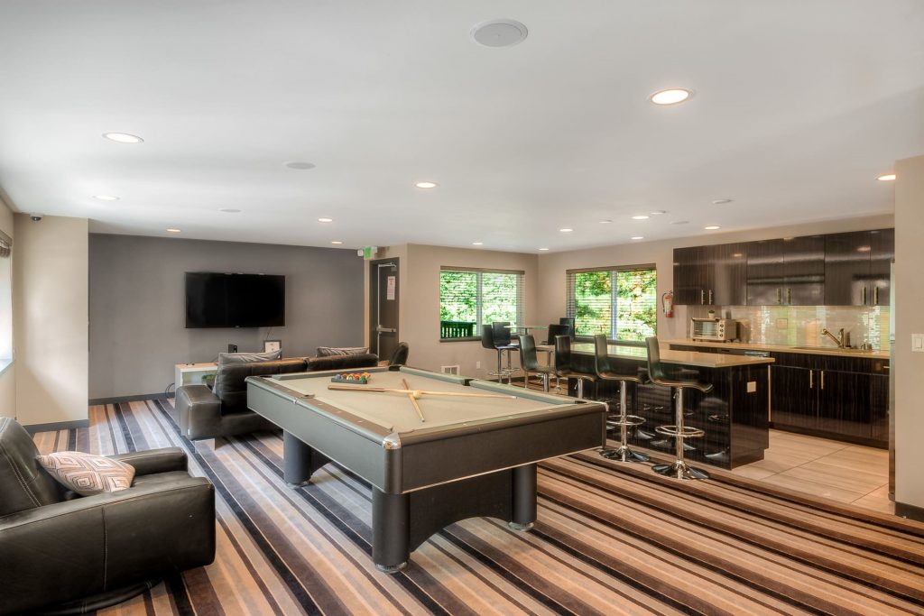 Game room with a pool table at Karbon Apartments in Newcastle, Washington