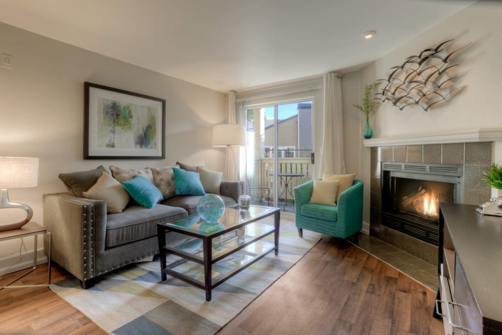 Living room with a fireplace at Newport Crossing Apartments in Newcastle, Washington